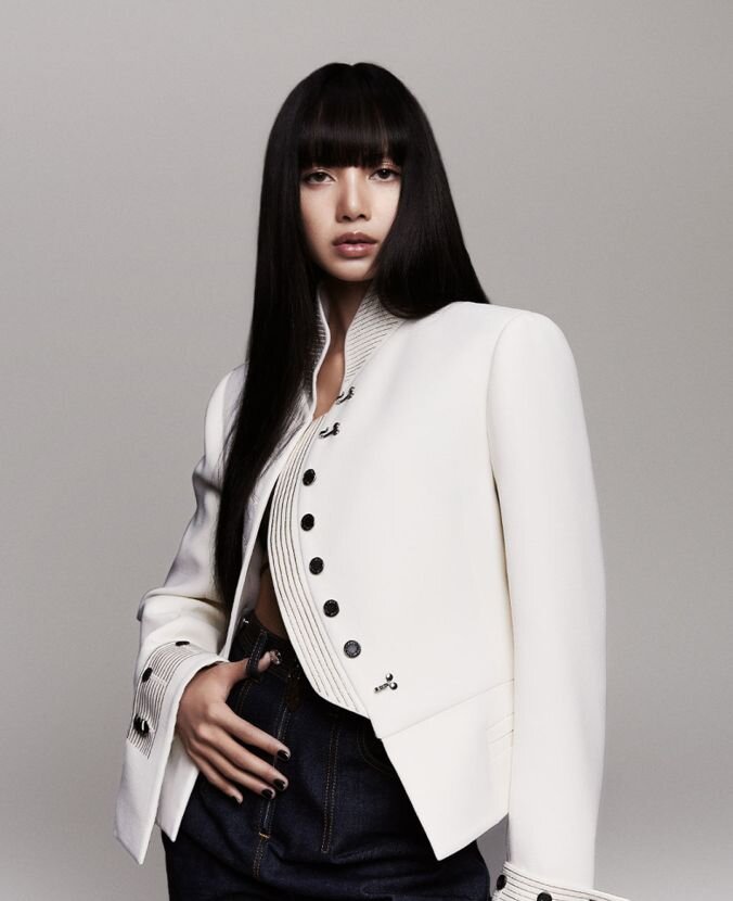 Lisa in a white Louis Vuitton jacket